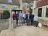 8 people standing together on steps outside a building.