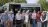 People standing in front of a minibus