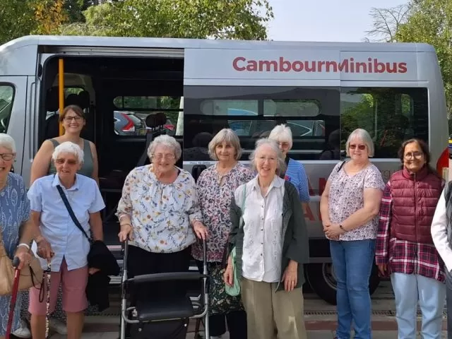 People standing in front of a minibus