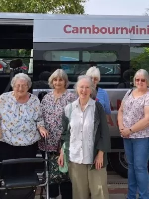 People standing in front of a minibus