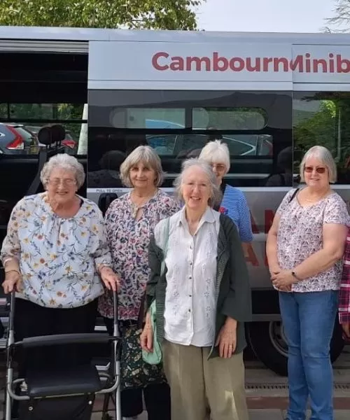 People standing in front of a minibus