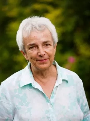 A headshot of Diana Lloyd against a green garden background