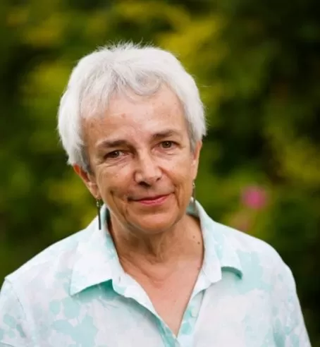 A headshot of Diana Lloyd against a green garden background