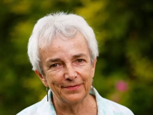 A headshot of Diana Lloyd against a green garden background