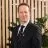 Headshot of Peter Burrows, CEO of The Cambridge Building Society, against a background of wooden panels and indoor plants.