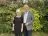 Stuart and Brenda Evans, the Foundation's supporters, standing in a garden in front of shrubbery.