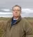 A headshot of Michael Sly, Vice President of the Foundation, standing outside in a field.