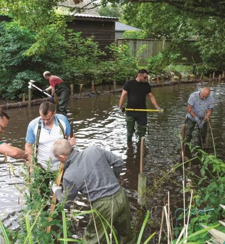 Volunteers in working along the river bank at Exning New River