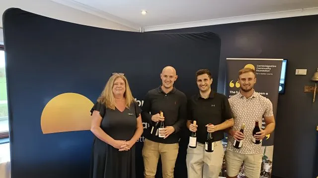 Winning team STG collect their prize from the Foundation's Viv Atkinson